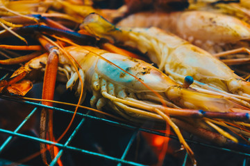 Delicious seafood prawn on grill with flames