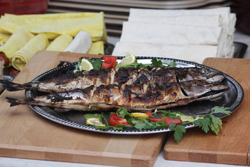 Baked fish lies on a platter. Food