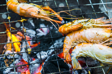 Delicious seafood prawn on grill with flames