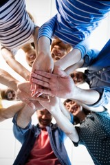 Fototapeta premium Creative business team stacking hands together
