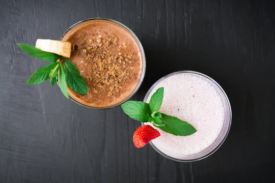 Blueberry smoothie with strawberry and banana smoothie on dark wood background. Fresh milkshake