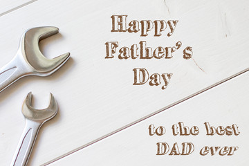 Happy Fathers day, tools with cable on white wooden background, best dad ever