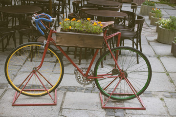 Fototapeta na wymiar Vintage stylized photo of Old bicycle carrying flowers as decoration