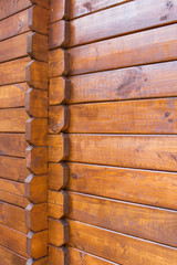 Closeup view of corner of wooden house made of natural logs - wooden construction background
