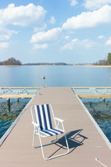 summer pier chair in the lake