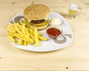 Burger and chips on wooden background