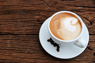 Hot latte coffee In white cup On the old wood table morning with copy space, minimal style