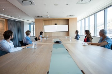Creative business team attending a video call in conference room