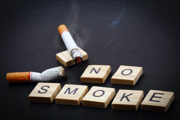 No smoke wording with cigarette on dark