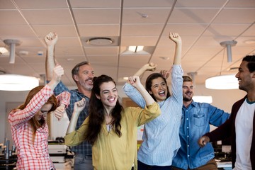 Happy creative business team celebrating success
