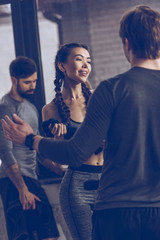 Fototapeta premium athletic young people talking in sportswear at the gym, fitness group concept