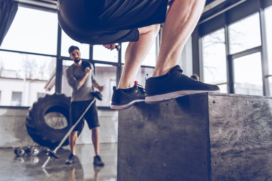 Close-up Partial View Of Sporty People Exercising At Cross Fit Gym Workout