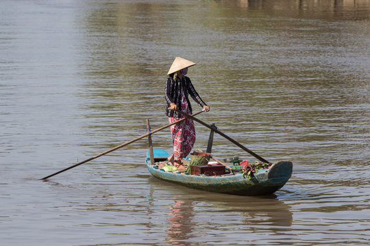 Vietnamese woman on a  wooden boat