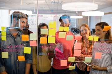 Creative business team looking at sticky notes 
