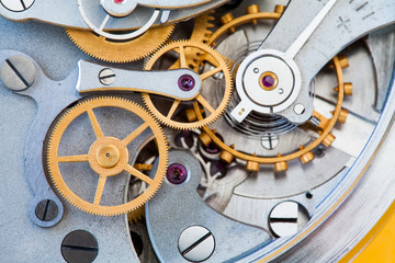 Clock transmission macro view. Stopwatch chronometer mechanism cogs gears wheels connection...