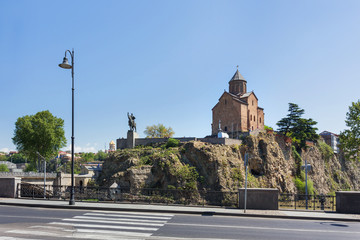 Fototapeta na wymiar Metekhi Church of the Dormition of the virgin. Monument to Vakhtang I Gorgasali. Famous landmark in Tbilisi, Georgia.