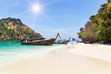 Fototapeta premium longtail boats with small island in andaman sea under blue sky at krabi Thailand