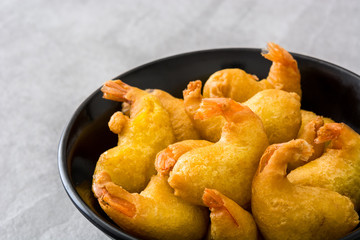 Deep fried shrimps in a bowl on gray stone

