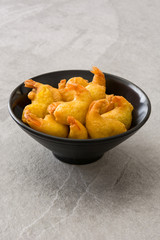 Deep fried shrimps in a bowl on gray stone

