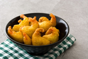Deep fried shrimps in a bowl on gray stone


