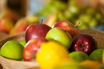 Close-up of fresh apples in wicker basket at organic section