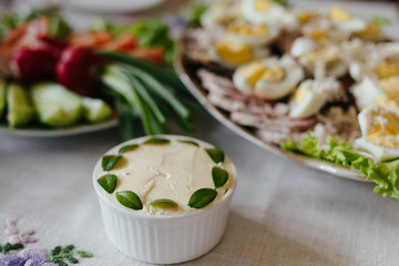 breakfast or brunch table setting full of healthy ingredients for a delicious easter meal with friends and family around the table