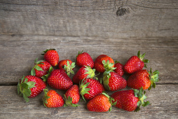 fresh strawberries on old wooden background
