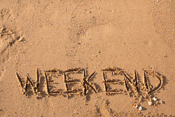 WEEKEND, written text on sand beach, it mean time for relax.