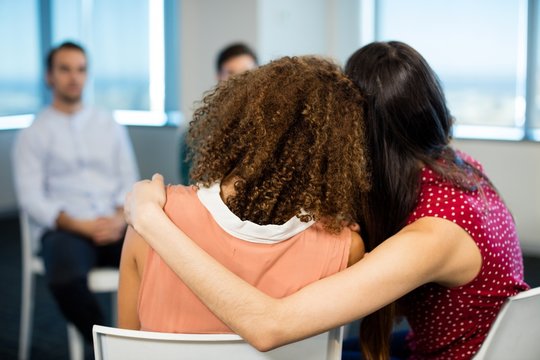 Creative businesswoman embracing each other at office