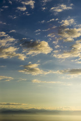 Naklejka na ściany i meble cloud sky sunrise as seen through window of an aircraft