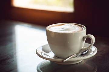 cup of coffee on wooden table
