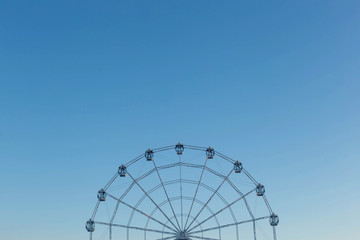 Fototapeta premium Ferris wheel against blue sky background