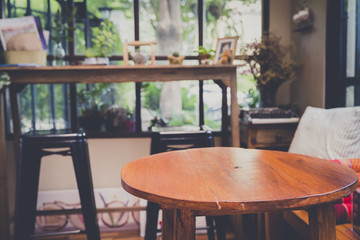 Round shape wooden table in vintage style room decoration. Concept of retro or vintage room