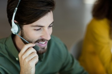 Smiling customer service executive talking on headset