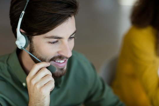 Smiling Customer Service Executive Talking On Headset