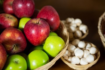 Naklejka na ściany i meble Close-up of small wicker basket full of apples