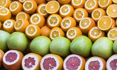 Background of fresh fruits of pomegranate oranges kiwi, pineapple 