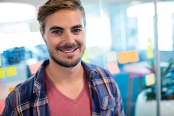 Smiling man standing against sticky notes 