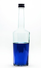 Blue alcohol bottle isolated. A half-filled bottle of blue alcohol.