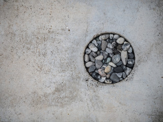 The gray stone is in the concrete hole.texture concrete background.