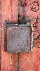 old rusty metal background with a box lock. The vertical frame.
