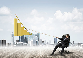 Man pulling with effort big pulling rope graph, as a symbol of financial growth