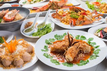 seafood in Restaurant, white plate on the Table , group many variety of meal