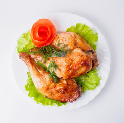 Grilled chicken legs with lettuce on plate