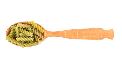 Green fusilli pasta in spoon on white background, top view