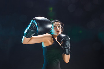 Plakat The female boxer training at sport club