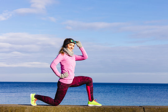 Woman fitness sport girl training outdoor in cold weather