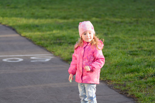 Little girl walks on the street