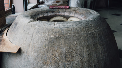 the availability of tandyr stove for baking bread. Traditional Asian oven for baking bread