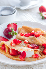 Breakfast with pancakes, fresh strawberries and tea, selective focus